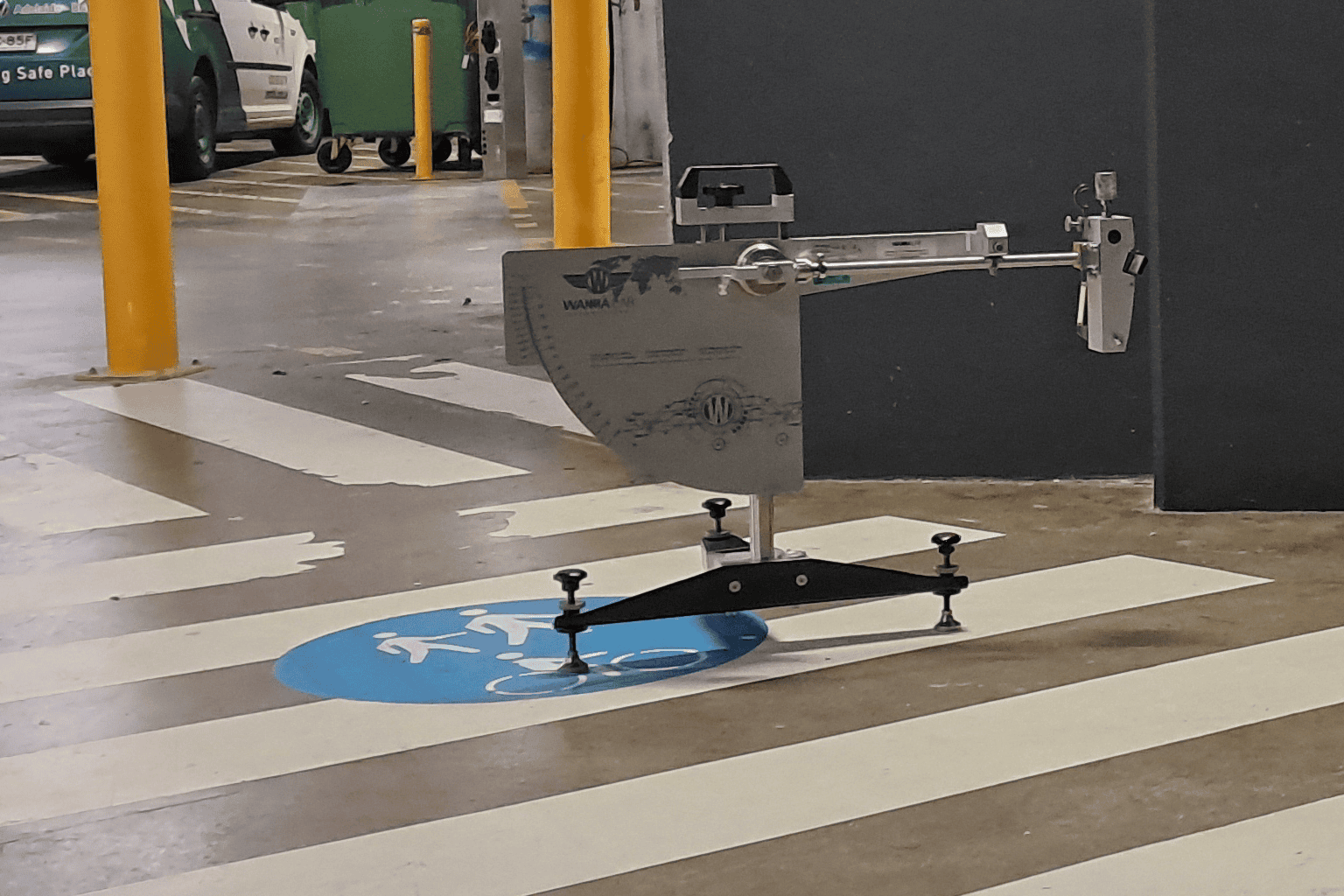 Wet pendulum slip resistance testing on a painted pedestrian surface in a car park walkway.