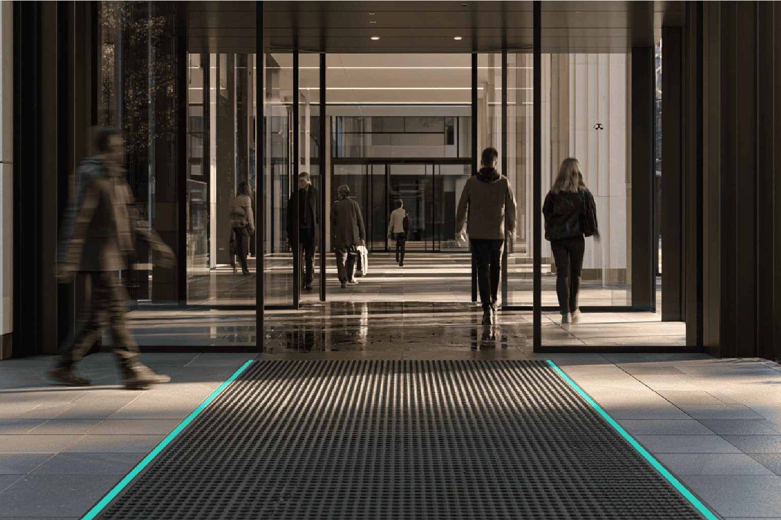Modern tiled entrance with tracked-in rain illustrating foreseeable slip risk despite compliant building design